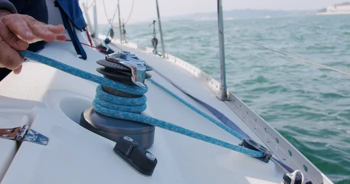 Rope being tied round an anchor point on a sailing boat.