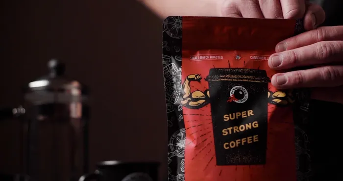 A red bag of cannonball coffee with the words super strong coffee in gold text